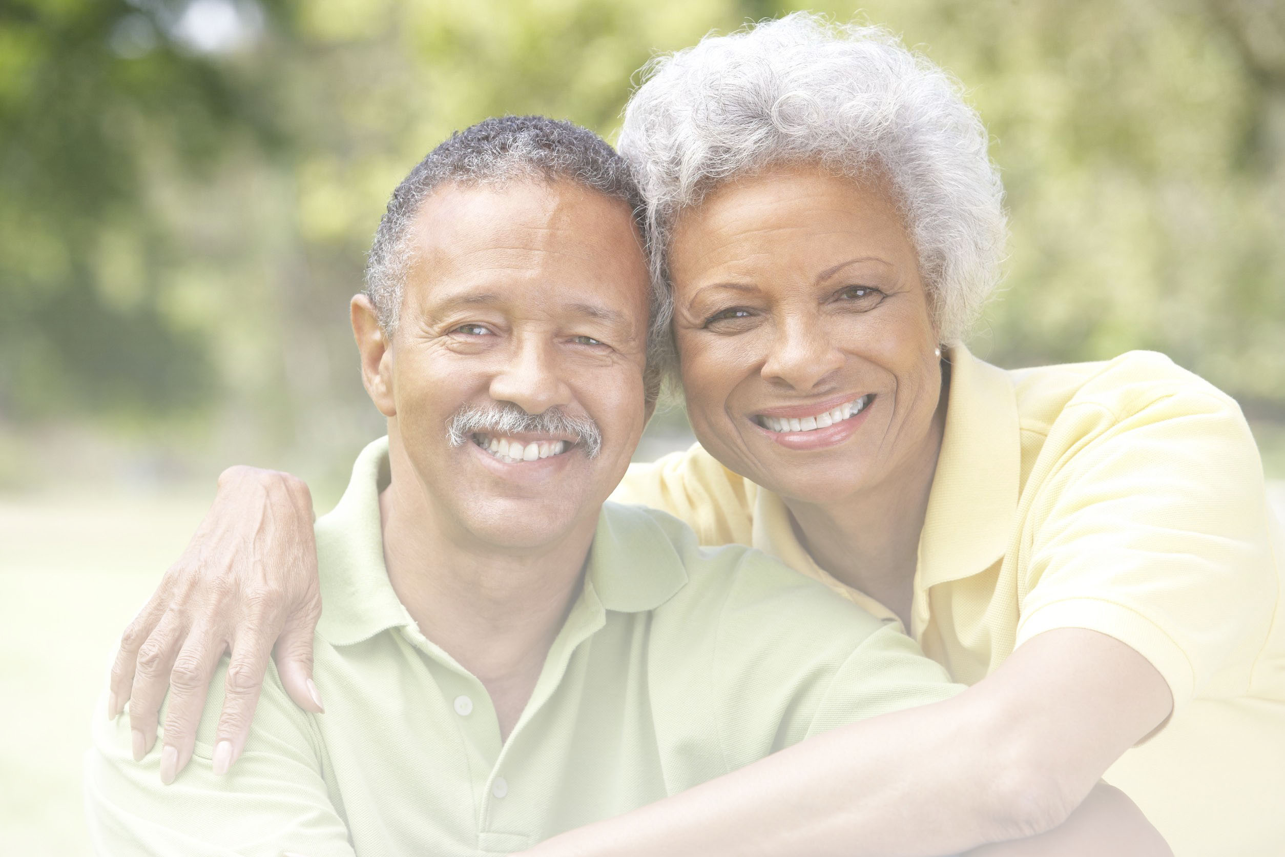 A retired couple smiling together outdoors